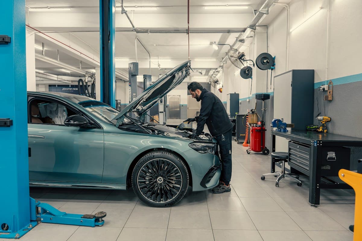 A car on a lift in a service workshop